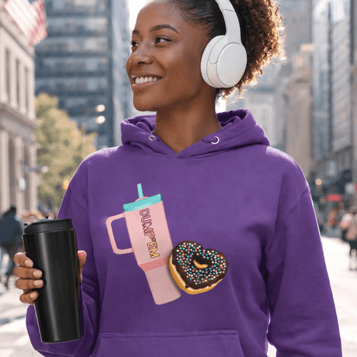 Purple hoodie with donut and tumbler graphic, worn by woman with headphones in city
