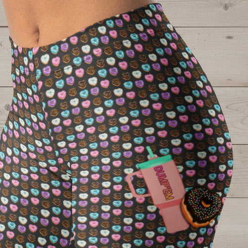 Colorful heart-patterned leggings with donut and 'DUMP'EM' cup graphic, fun retro fitness wear