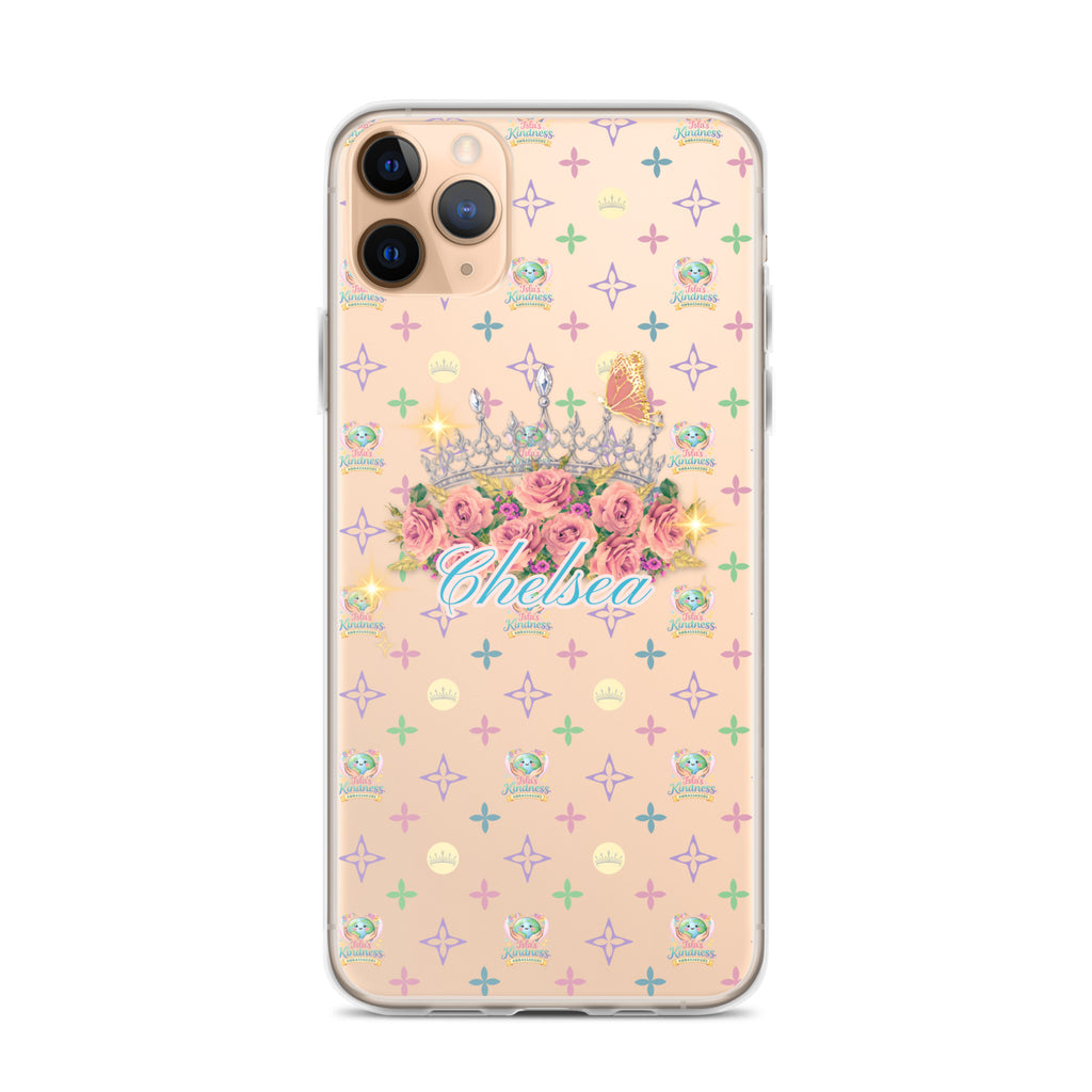 A clear iPhone case with a pastel pink background, featuring a repeating pattern of small colorful crosses and monogram motifs, with a central graphic of a tiara, pink roses, a butterfly, and the name 'Chelsea' in blue script.