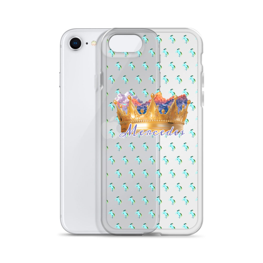 A clear phone case shown on a white smartphone, featuring a repeating pattern of small turquoise birds and a large gold crown graphic with the word 'Mercedes' in purple script across the center.