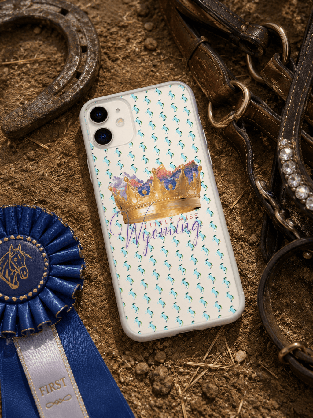 Little Miss Wyoming phone case with crown & horse pattern, styled with rodeo ribbon, horseshoe, and bridle
