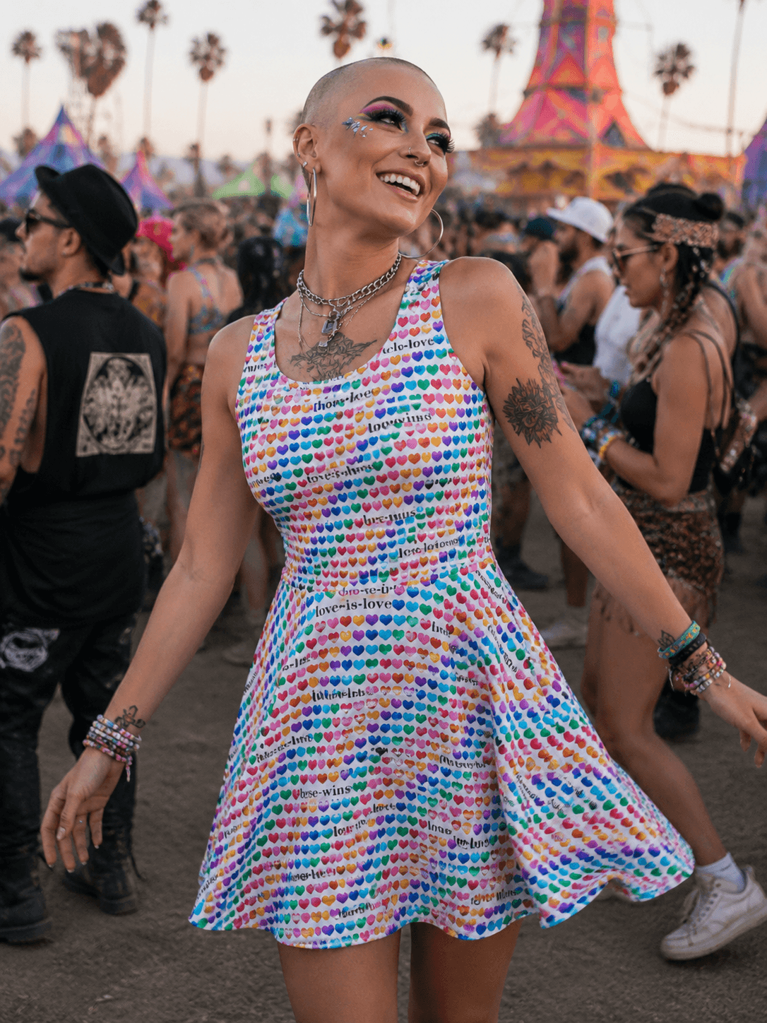 Woman dancing at festival in colorful heart print dress with 'love is love' text, vibrant festival fashion