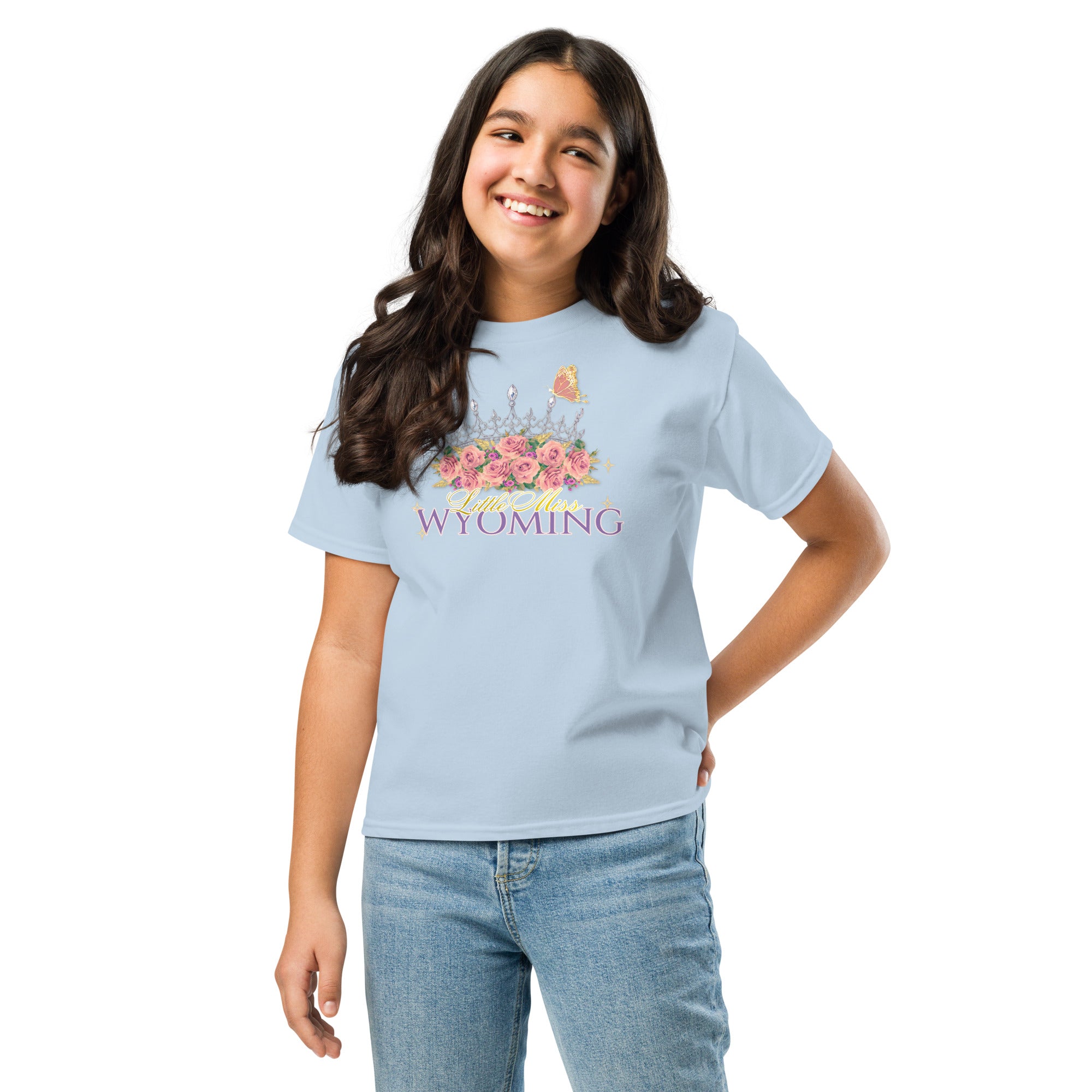 Girl wearing a light blue t-shirt with colorful design on a white background