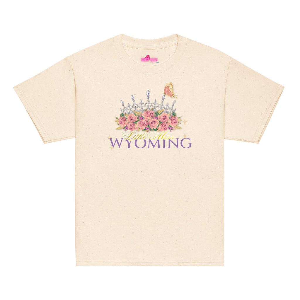 A cream-colored short-sleeve t-shirt with a graphic on the front featuring a crown, pink roses, a butterfly, and the text 'Wild West WYOMING'.